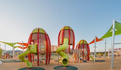 Faye Carr Park Ripley Australia featuring three rocket-shaped tower play structures for 5 to 12.  In addition a Cube play structure for kids ages 2 to 5, and to round out this play environment, a double ZipKrooz®, Global Motion®, We-saw™.