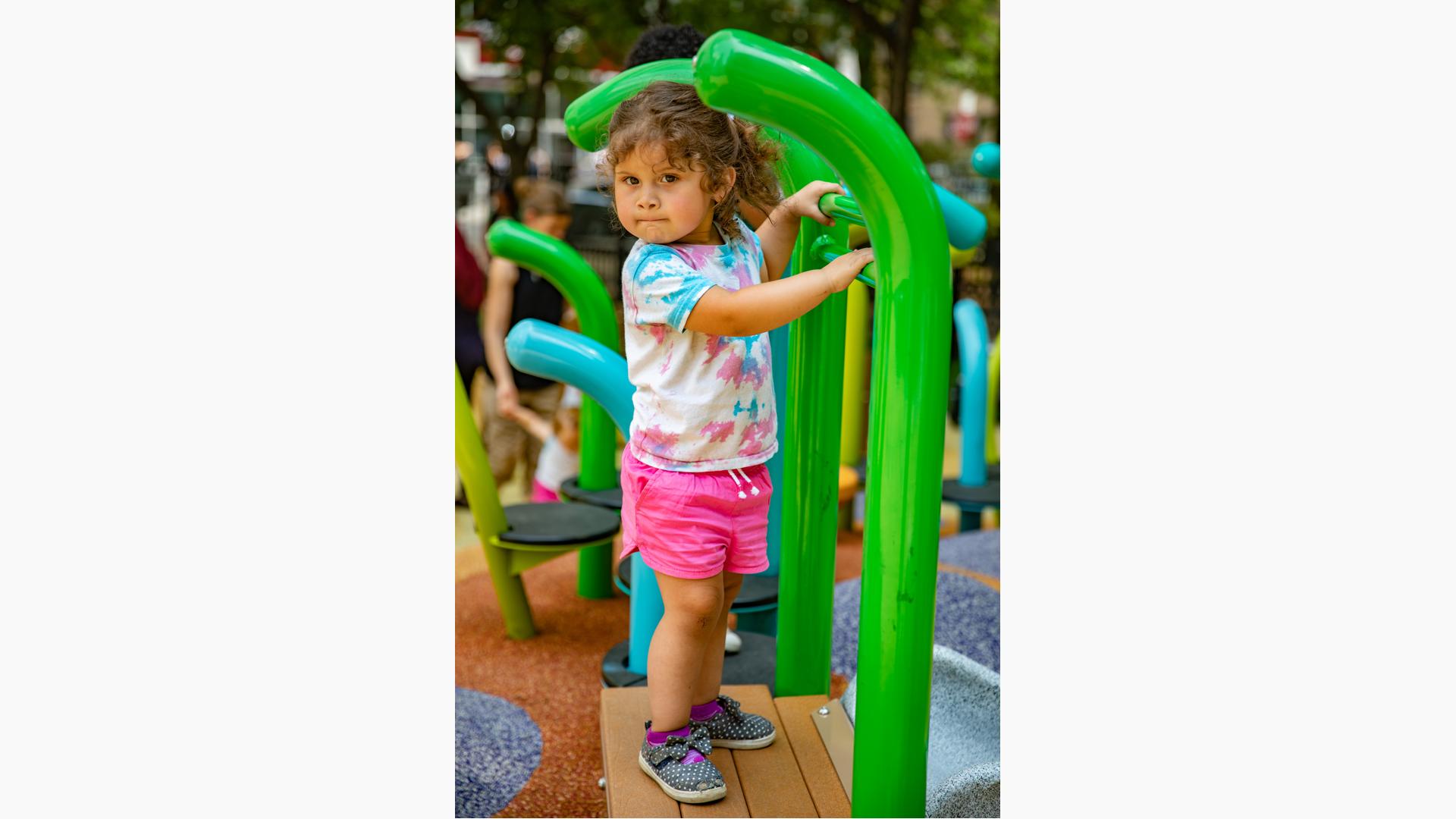 Little girl playing near Noodle Pod® Step