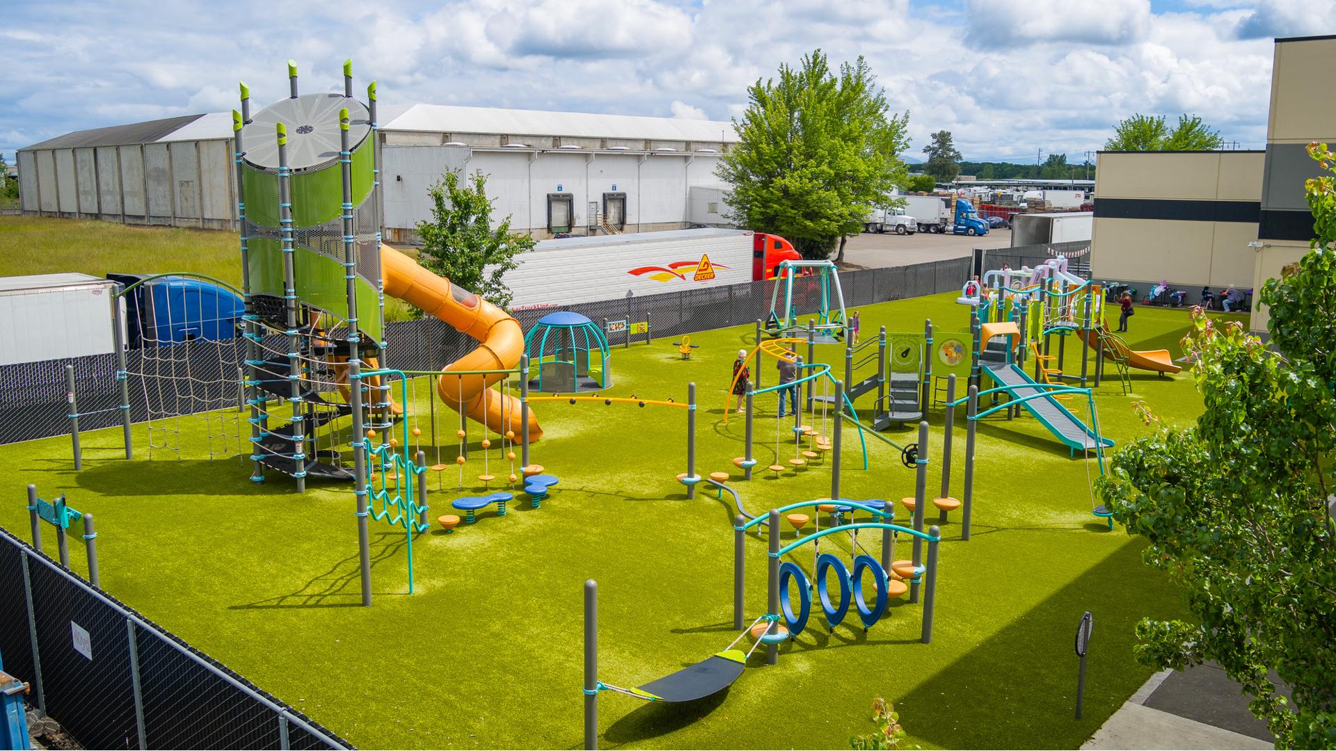 Elevated view of a large playground outside a YMCA building.
