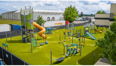 Elevated view of a large playground outside a YMCA building.