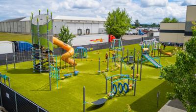 Elevated view of a large playground outside a YMCA building.