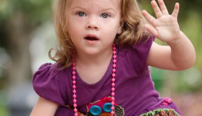 Toddler girl in purple dress