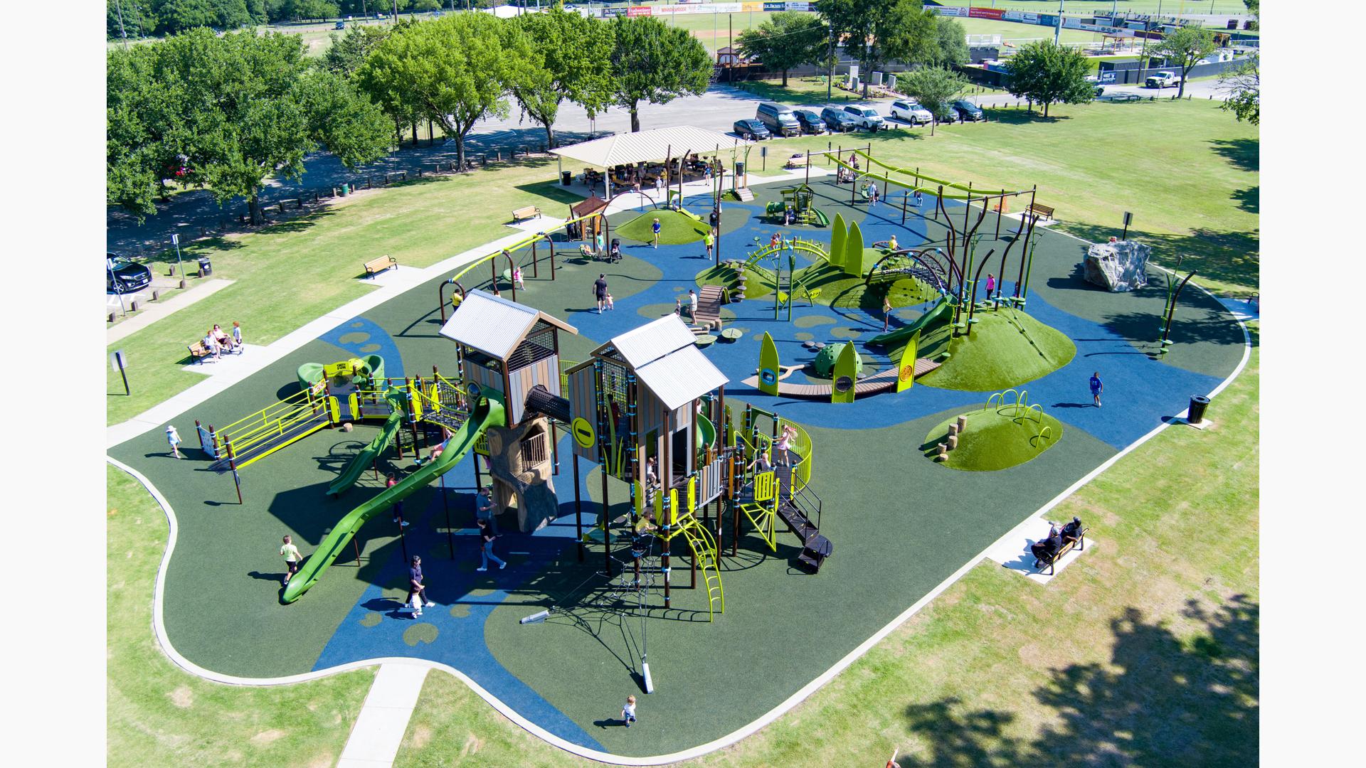 Elevated view of a nature themed playground at a town park.