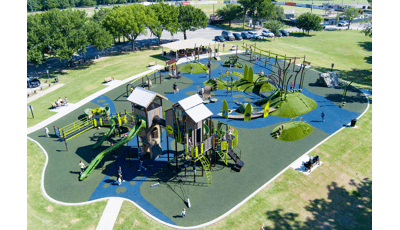 Elevated view of a nature themed playground at a town park.