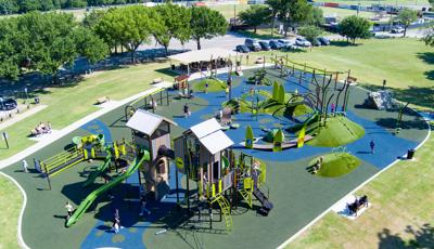 Elevated view of a nature themed playground at a town park.
