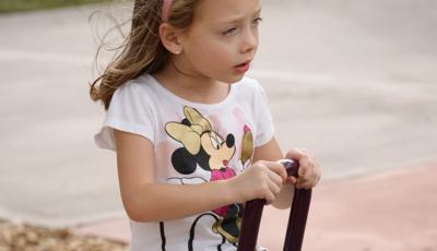 Girl sitting on see-saw