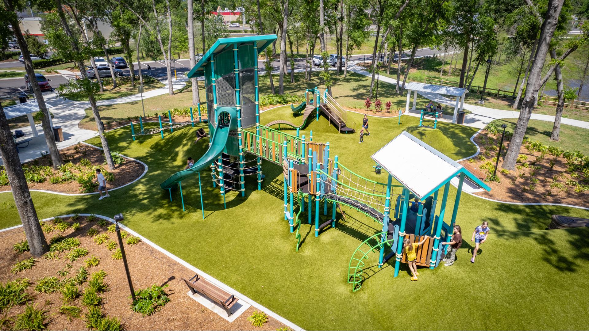 Elevated view of an outdoor park playground on artificial grass surfacing.