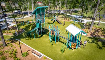 Elevated view of an outdoor park playground on artificial grass surfacing.