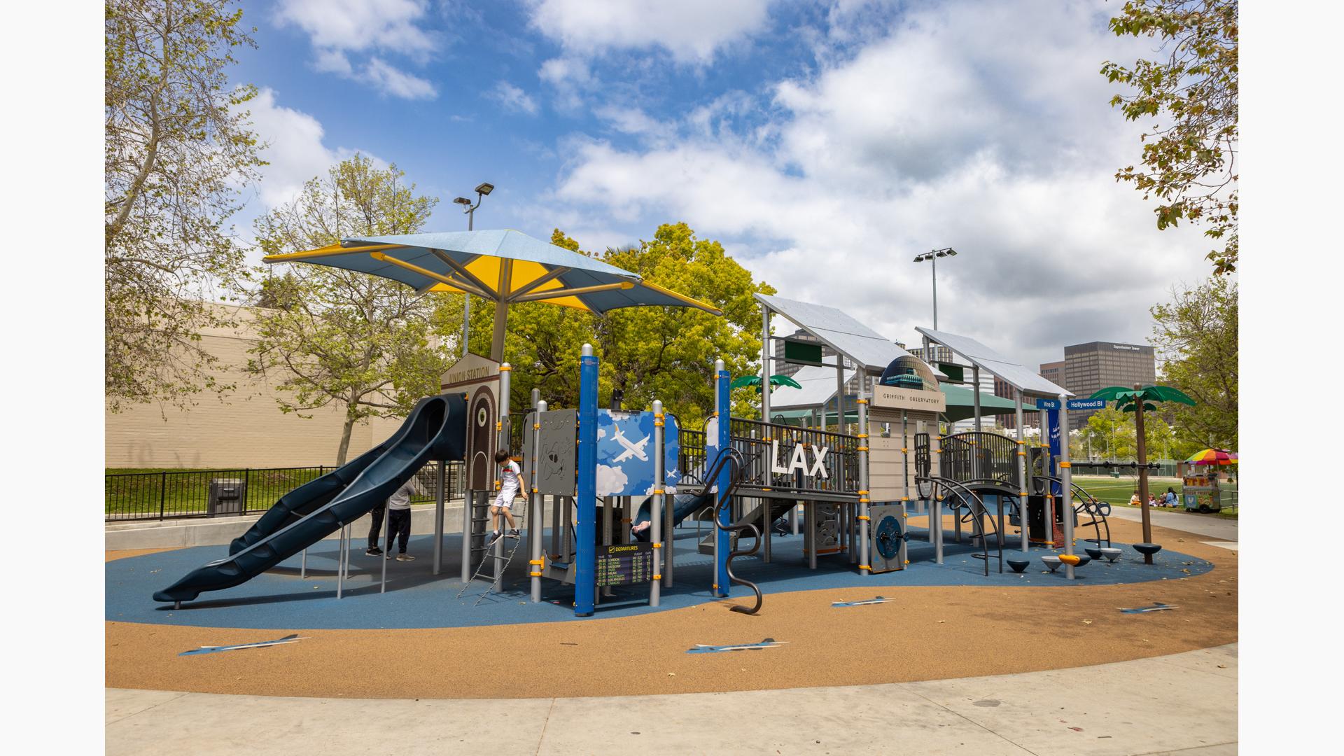 A child plays on a LAX Airport and airplane themed playground.