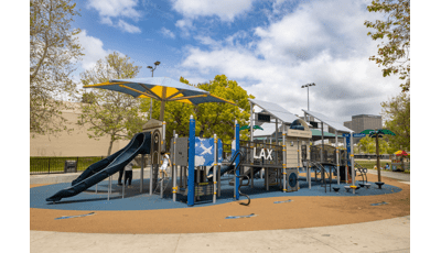 A child plays on a LAX Airport and airplane themed playground.