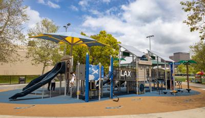 A child plays on a LAX Airport and airplane themed playground.