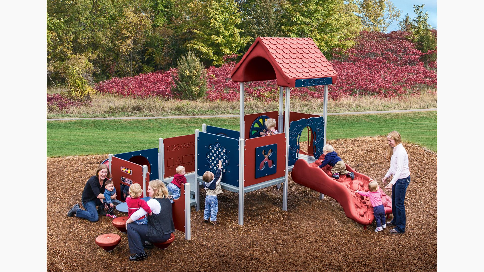 Mothers play with their children on a toddler accessible playground structure.  