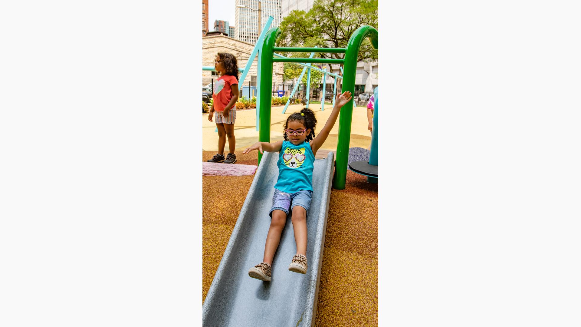 Girl riding slide