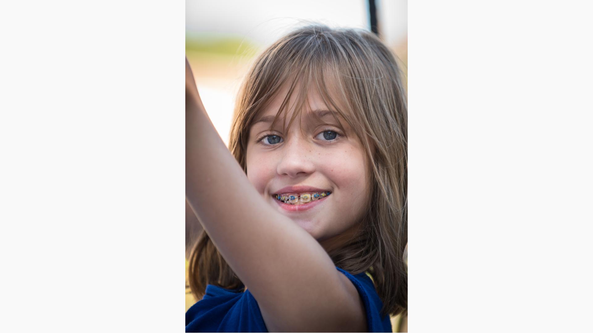 New Zealand Photos  Young girl smiling and sharing a rope swing