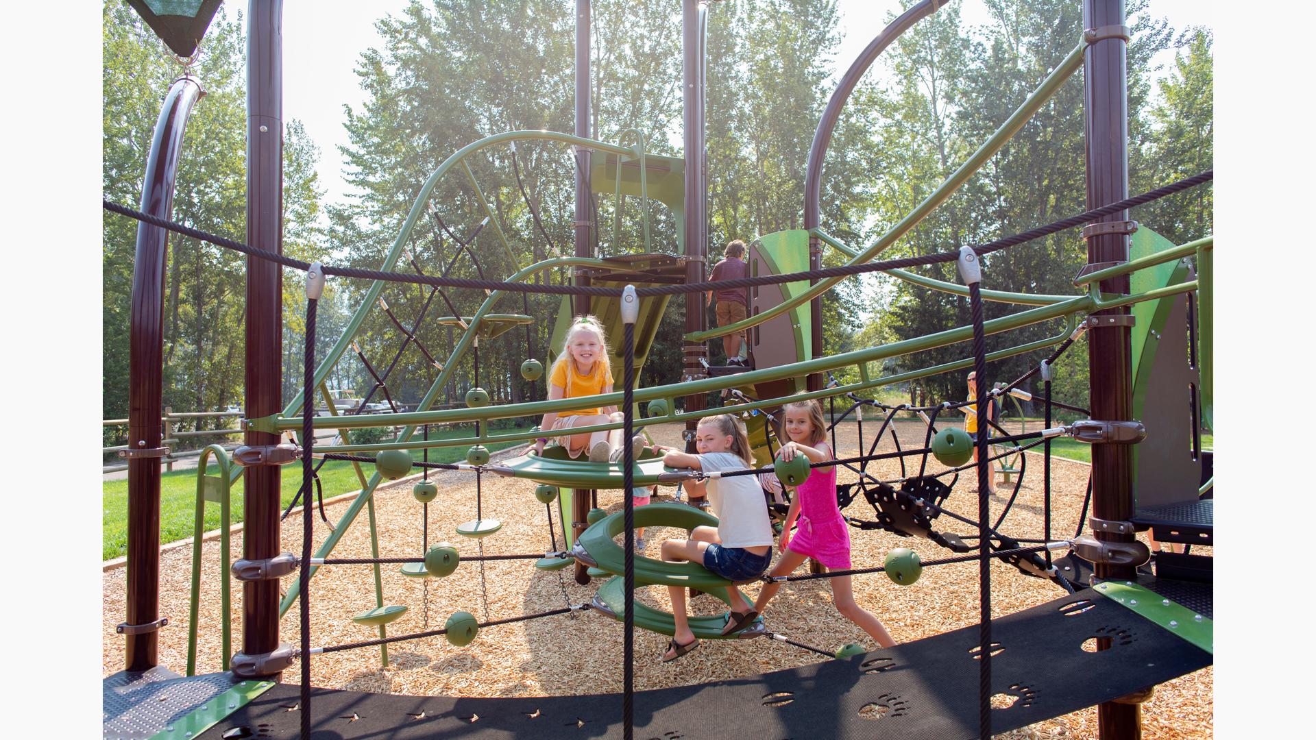 Girls sitting and smiling on playground