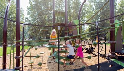Girls sitting and smiling on playground