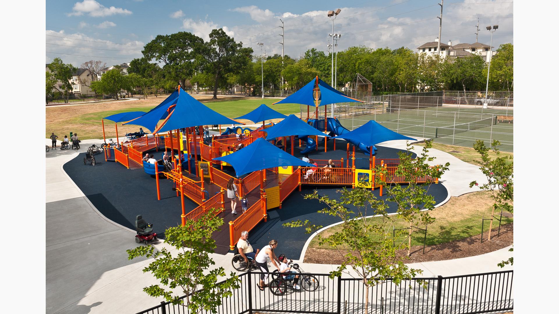 Metropolitan Multi Service Center Houston, TX. A brightly colored PlayBooster® play structure is connected by a series of ramps so all kids can access the many innovative inclusive and sensory activities. Such as the Sway Fun® glider, Sensory Play Center® and CoolToppers®.