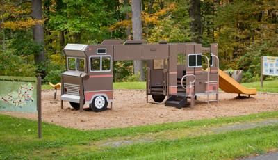 Custom playground designed to look like a an RV or motorhome parked at a campground