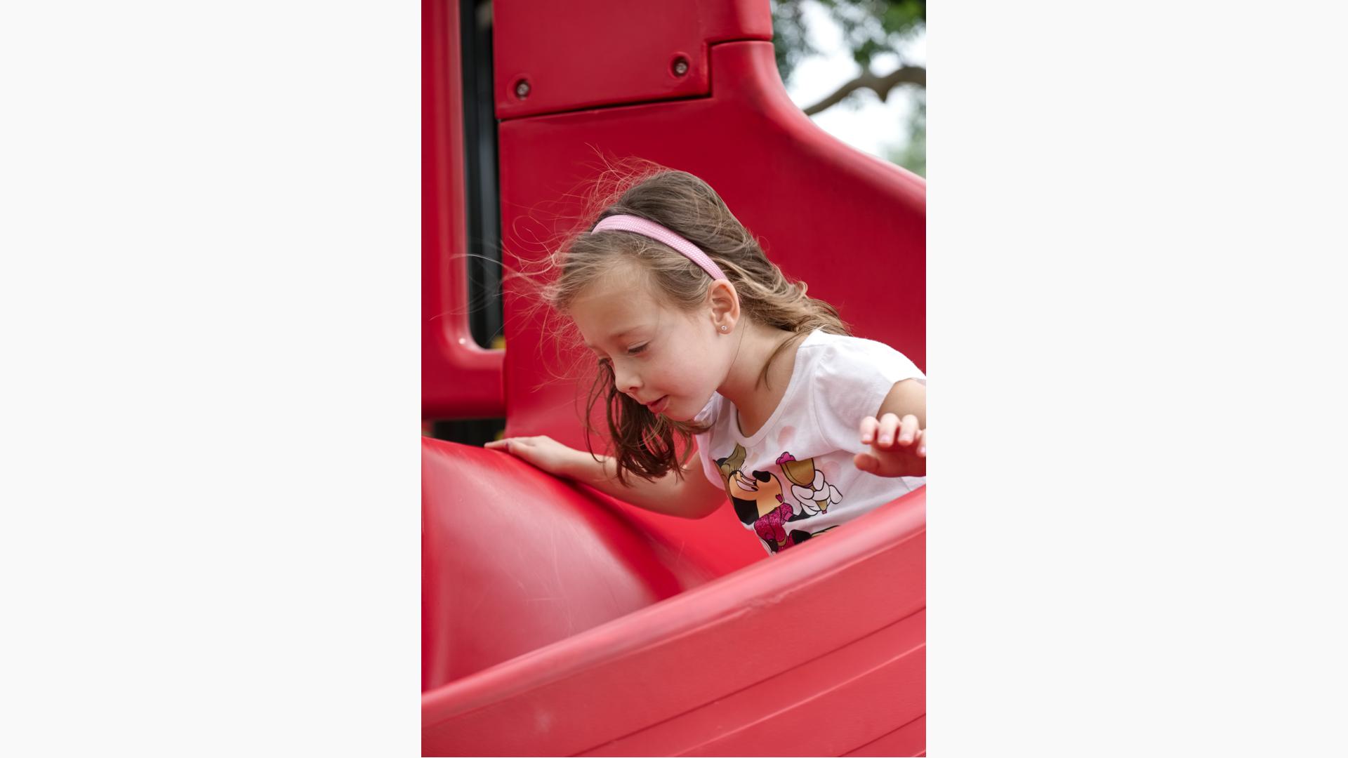 Woman Sliding Down Hill on Kids Ride on Toy