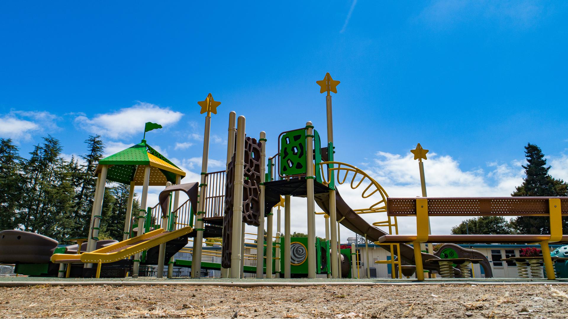 Ponderosa Elementary playground with star accents and view of geoplex climber