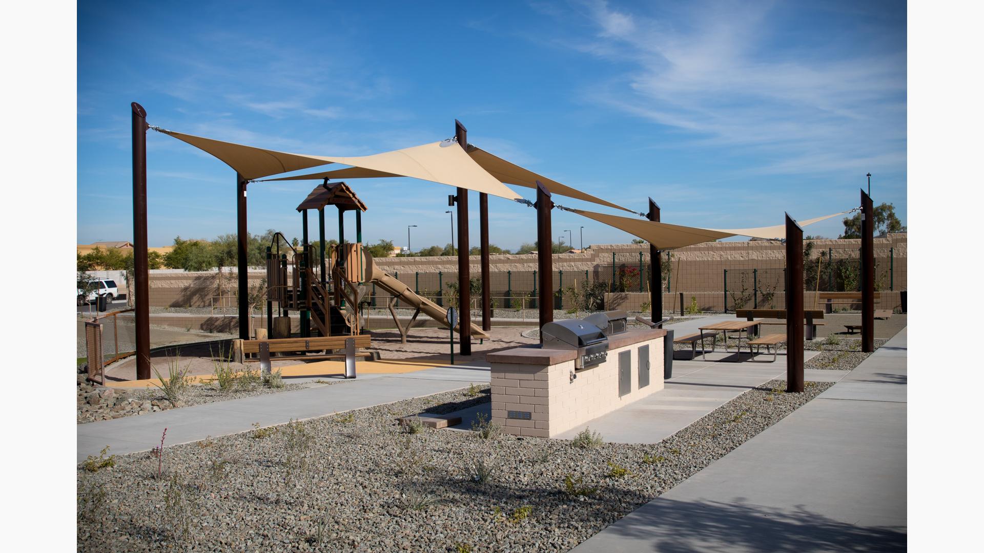 Nature-inspired PlayBooster play structure covered by custom SkyWays shade sails.