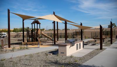 Nature-inspired PlayBooster play structure covered by custom SkyWays shade sails.