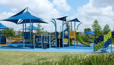 Dylan Park is home to a brightly colored PlayBooster® playstructure featuring the Sway Fun® Glider, Rollerslide and OmniSpin® Spinner. The Cascade Climber and a Sensory Play Center® and several CoolToppers® shade products.