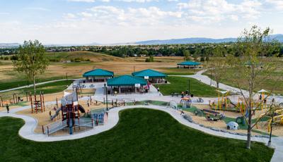 A very large playground with several play areas - including a trombone-themed play structure