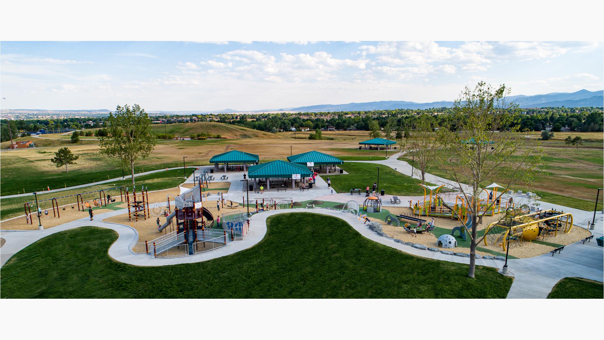 A very large playground with several play areas - including a trombone-themed play structure