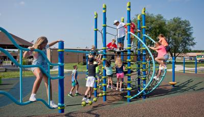 Girl on JigJag Climber w/Kids playing on Netplex® play structure