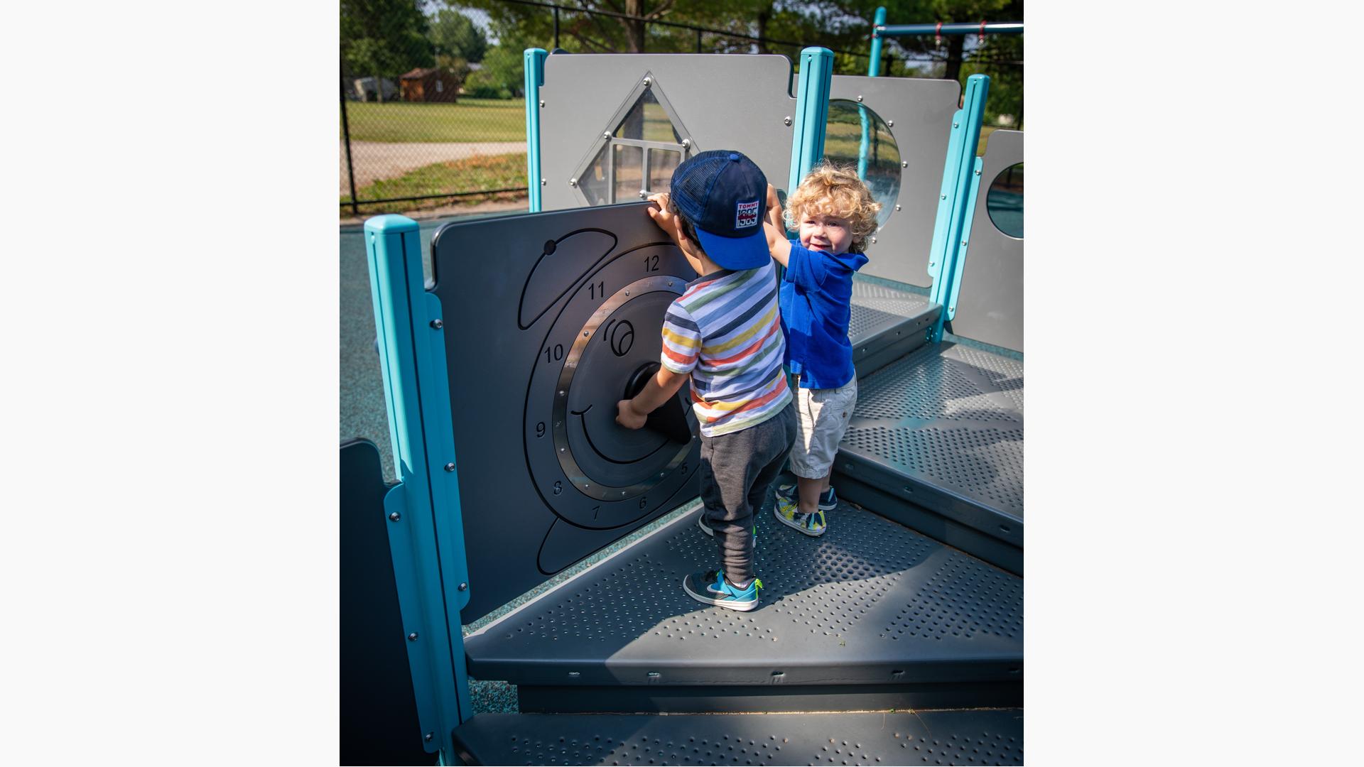 Children playing on clock panel