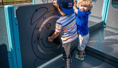 Children playing on clock panel