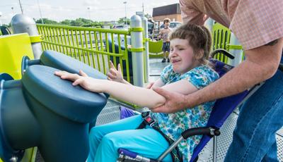 Girl learning to use Bongo Reach Panel