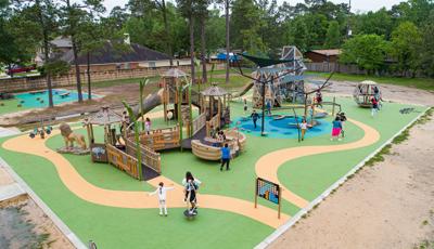 Children play on an inclusive safari themed outdoor playground.