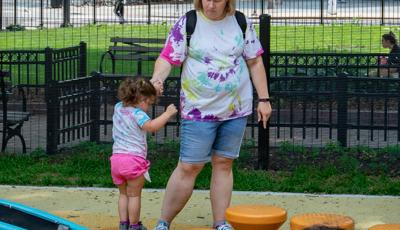 Mom helping little girl on Spring Pod™ Bouncer