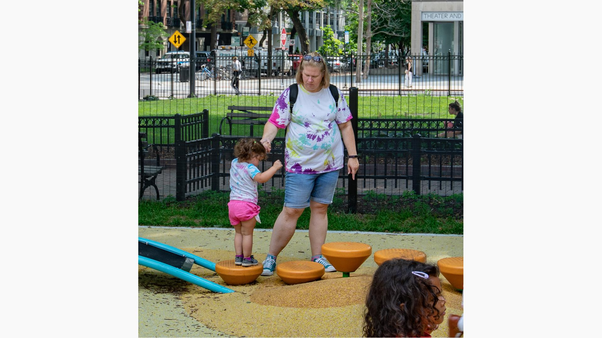 Mom helping little girl on Spring Pod™ Bouncer