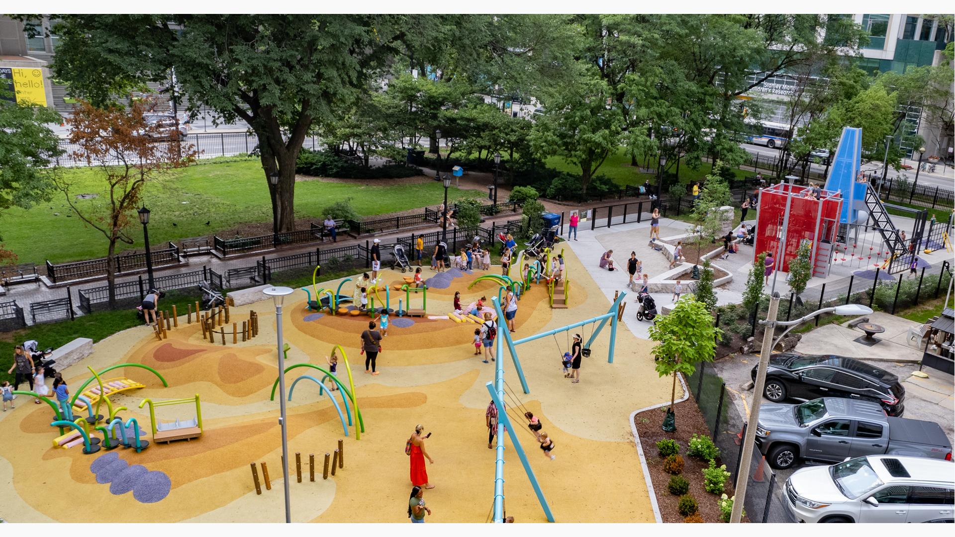 Elevated view of a colorfully surfaced city park  with building inspired play structure and modern themed freestanding play activities. 