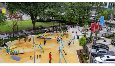 Elevated view of a colorfully surfaced city park  with building inspired play structure and modern themed freestanding play activities. 