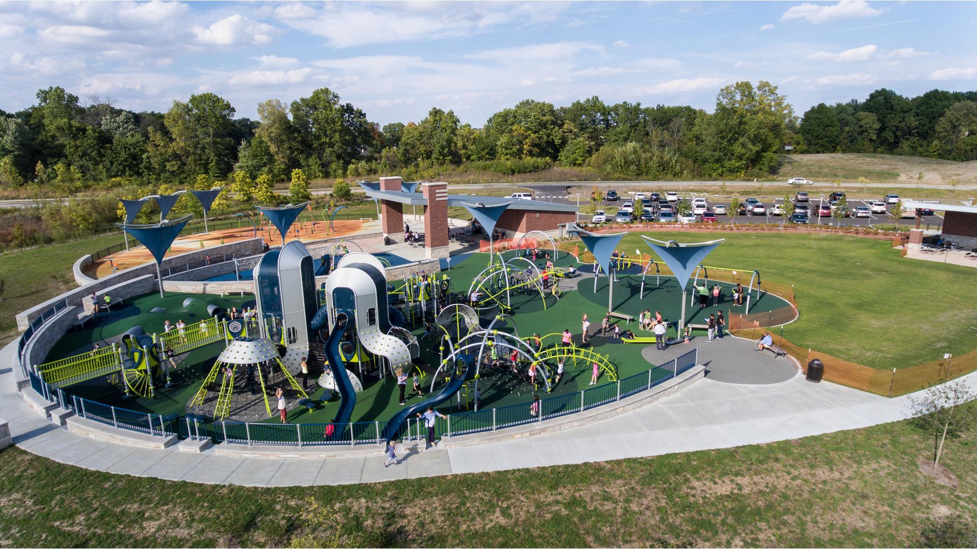 Families pack in to West Commons Playground at Central Park for numerous play activities. 