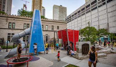 GIrl standing on trampoline next to custom play structures