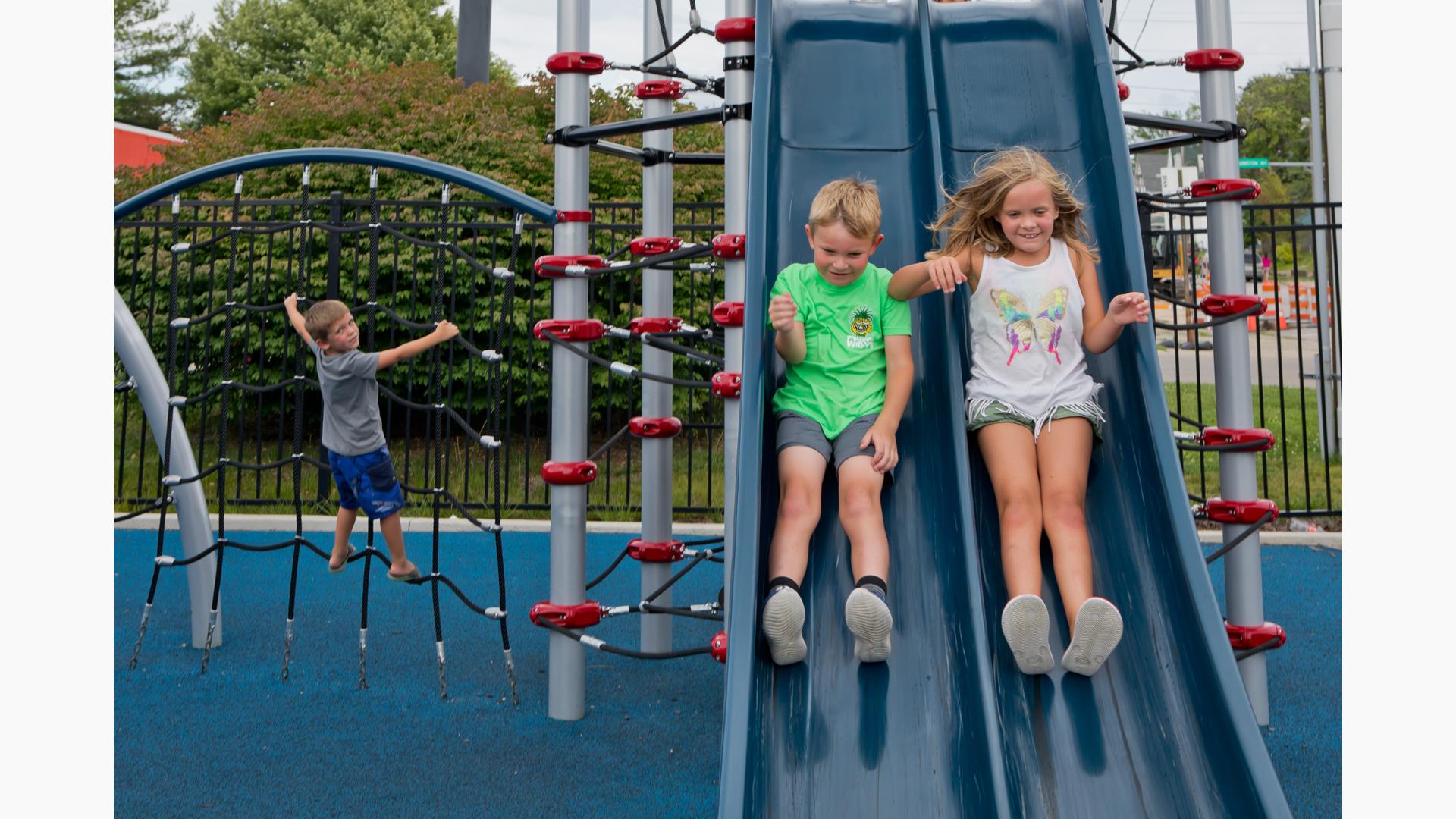 Children riding down slide