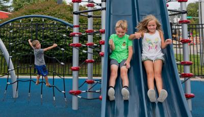 Children riding down slide