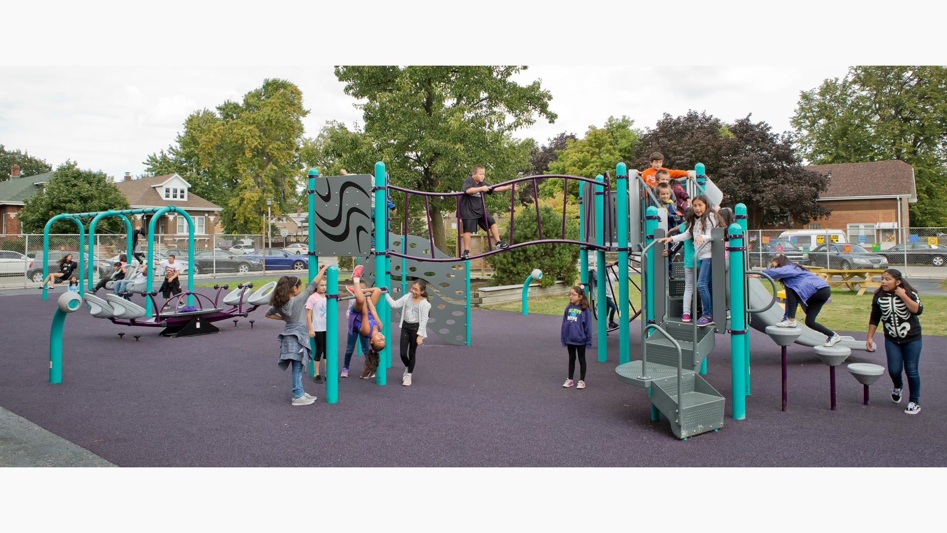 Komensky Elementary playground in Berwyn, IL, brought by KABOOM! features a Cascade Climber, a Canyon Climber, and a Double Swoosh Slide®. The PlayBooster® play structure also features freestanding play components like the We-Saw™, Saddle Spinners, Bobble Riders and swings. Best of all, the playground incorporates the school colors.