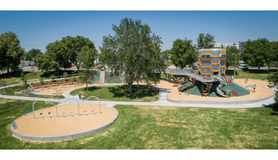 The sun shines down on Paco Sanchez Park
in Denver, CO as kids play inside the giant vintage vocal mic -inspired tower.