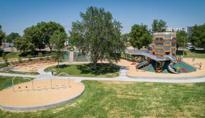 The sun shines down on Paco Sanchez Park
in Denver, CO as kids play inside the giant vintage vocal mic -inspired tower.