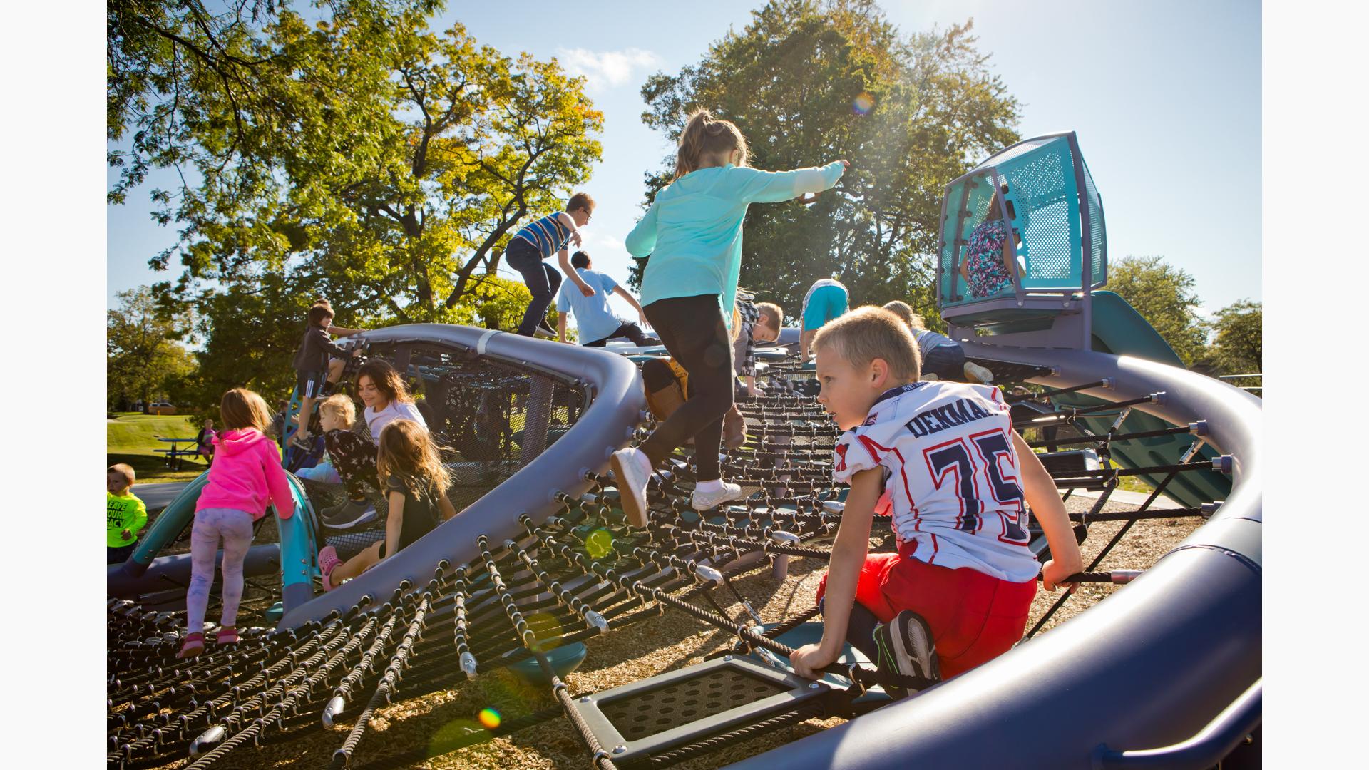 Childdren climing on Quantis playscape in Palmer Park