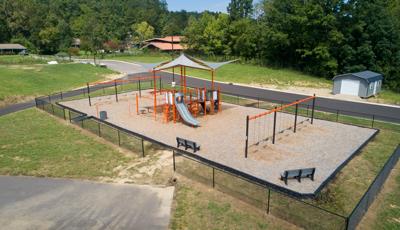 Compact playground with built-in shade and two banks of swings for kids ages 5 to 12