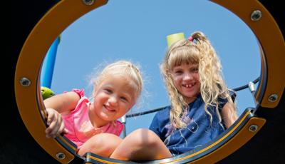 Two girls smiling on Netplex® play structure