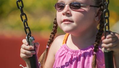 LIttle girl in bucket swing