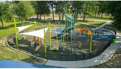 Elevated view of a nature themed playground with structures shaped like a rabbit, fish, and dragonfly.